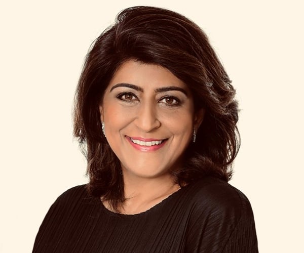Rashmy Chatterjee, lächelnd, schaut in die Kamera.