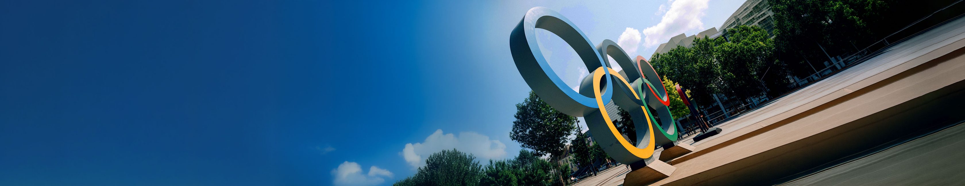 Olympic rings sculpture outdoors in a city setting, symbolizing the Olympic and Paralympic Movements and their global partnership with Allianz as the global insurance partner.