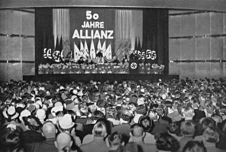 Uniforms and flags signify the politicization of everyday life in the company.