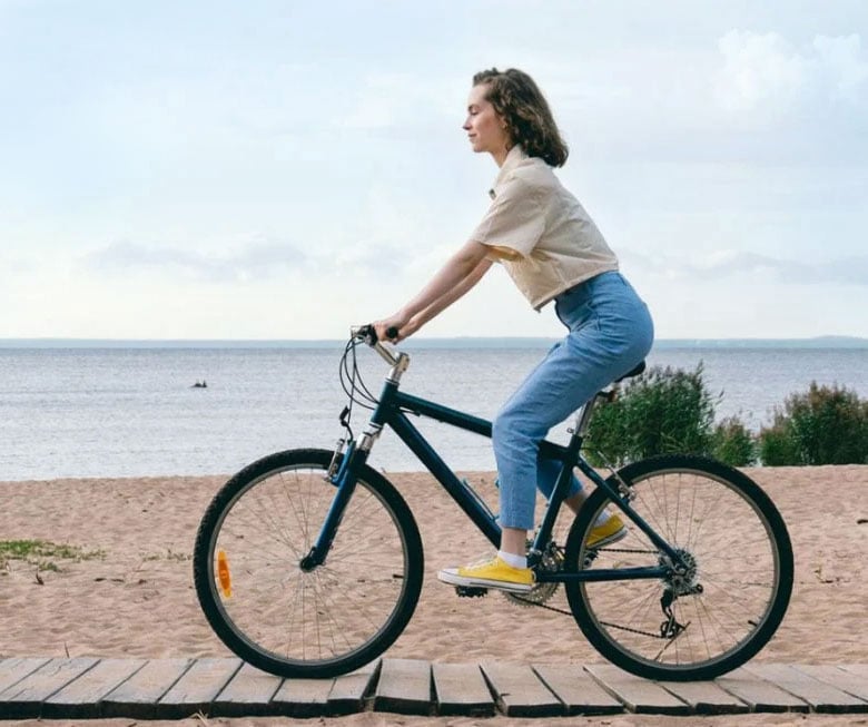 Girl on a bike on the coast