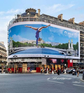 Opéra Place showcases a rhythmic gymnastics athlete doing a handstand on the Alexandre III bridge