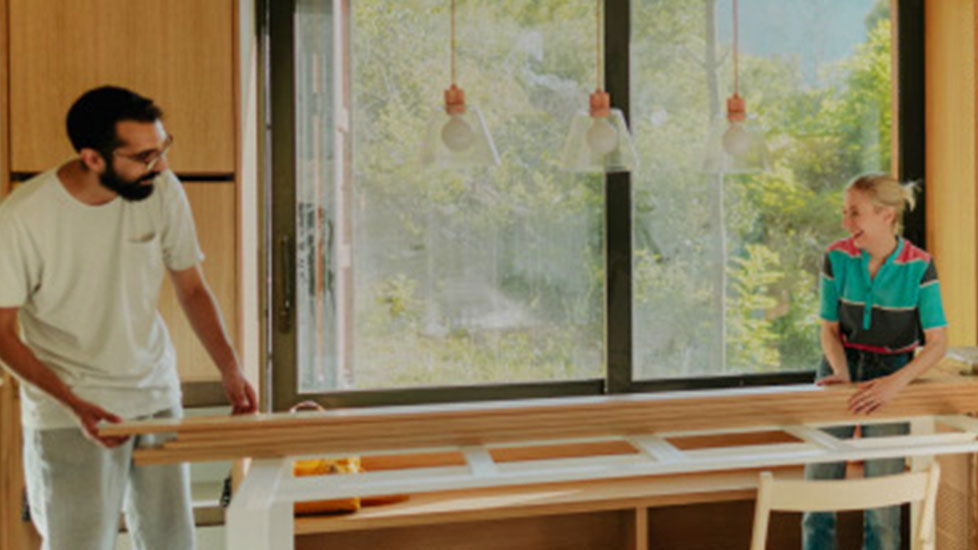 Two people doing renovation work on their house