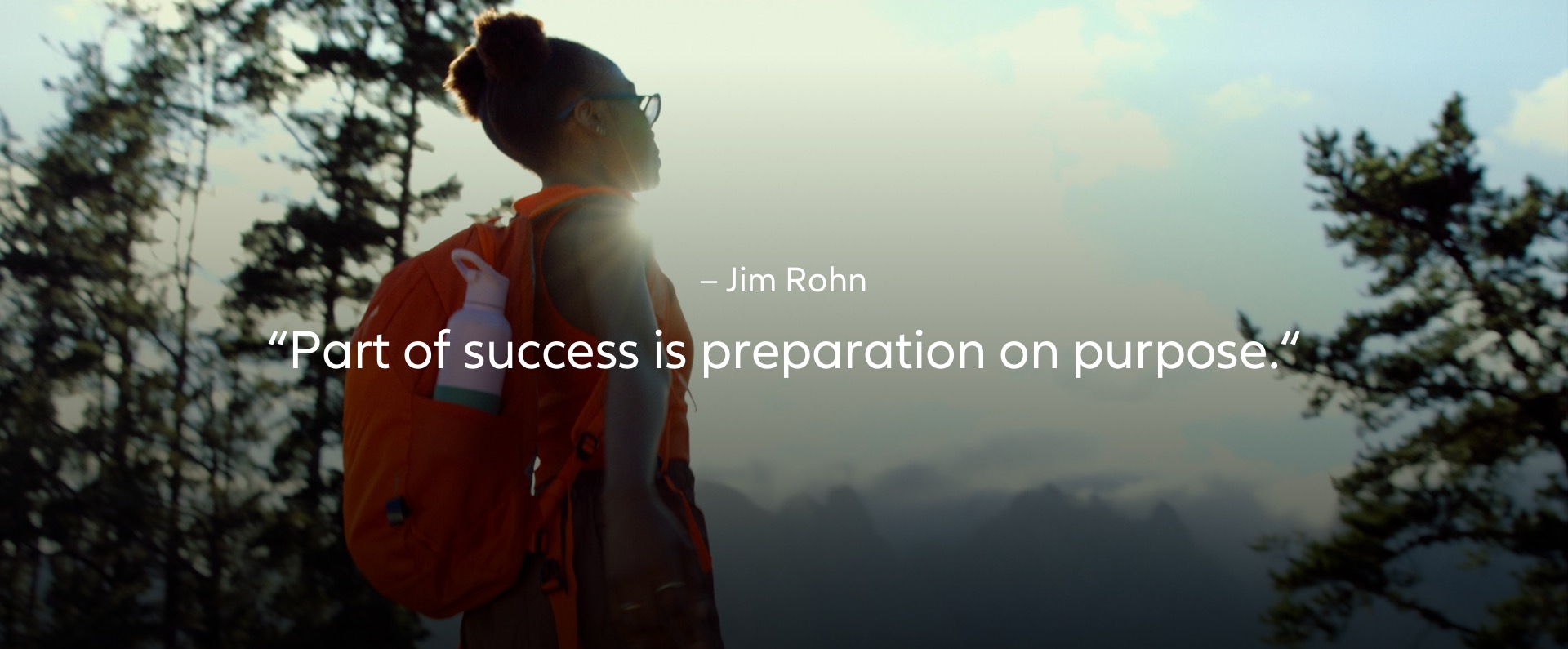 Jim Rohn – "Part of success is preparation on purpose." quote with a woman before the start of hiking up a mountain