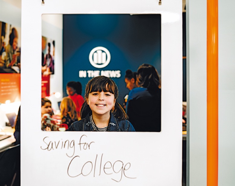 Girl laughing and looking out of a paper frame with the subline "saving for college"