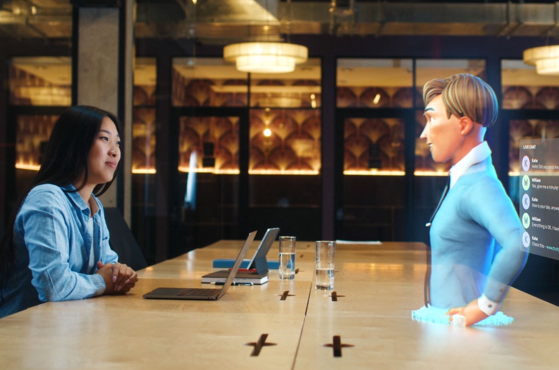 Woman talking to a hologram man from the metaverse at a table