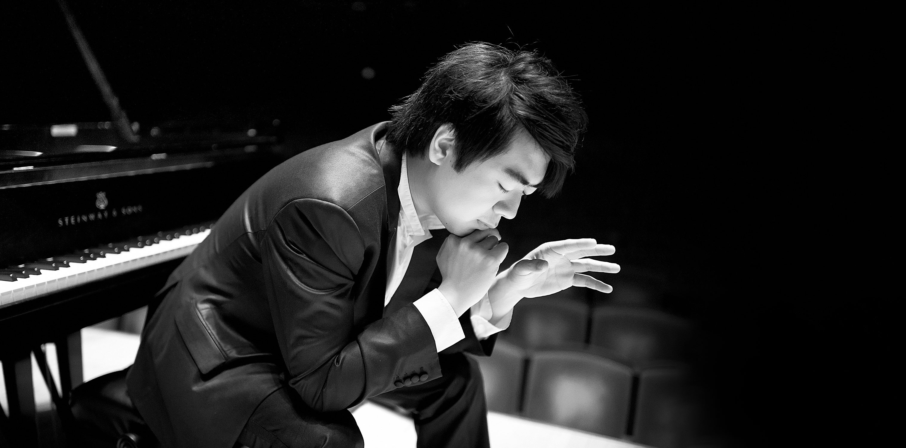 Pianist Lang Lang concentrated sitting in front of a piano
