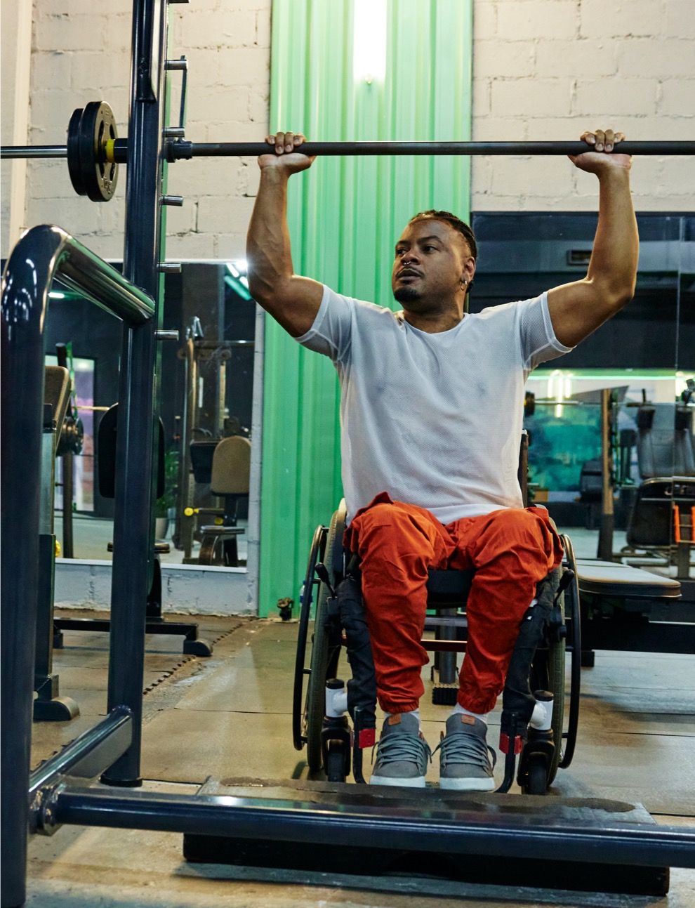 Athlete in a wheelchair training with weights