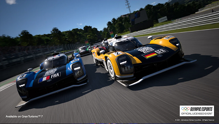 An in-game visual from Gran Turismo 7 showing two Toyota cars racing close two each other, while one being painted in the colours of France and one in the colours of Germany.