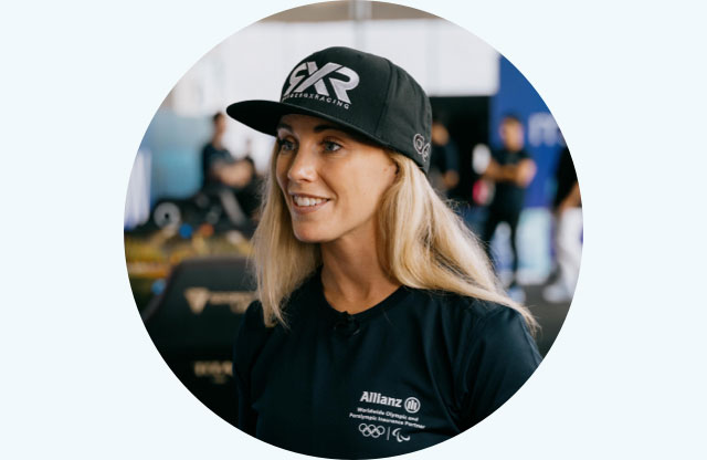 Mikaela Åhlin-Kottulinsky is wearing her MoveNow Camp shirt and a cap with the logo of her racing team while giving an interview.