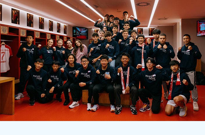 Group photo of all participating young people on a tour of FC Bayern's home ground and a visit at the dressing room inside the Allianz Arena