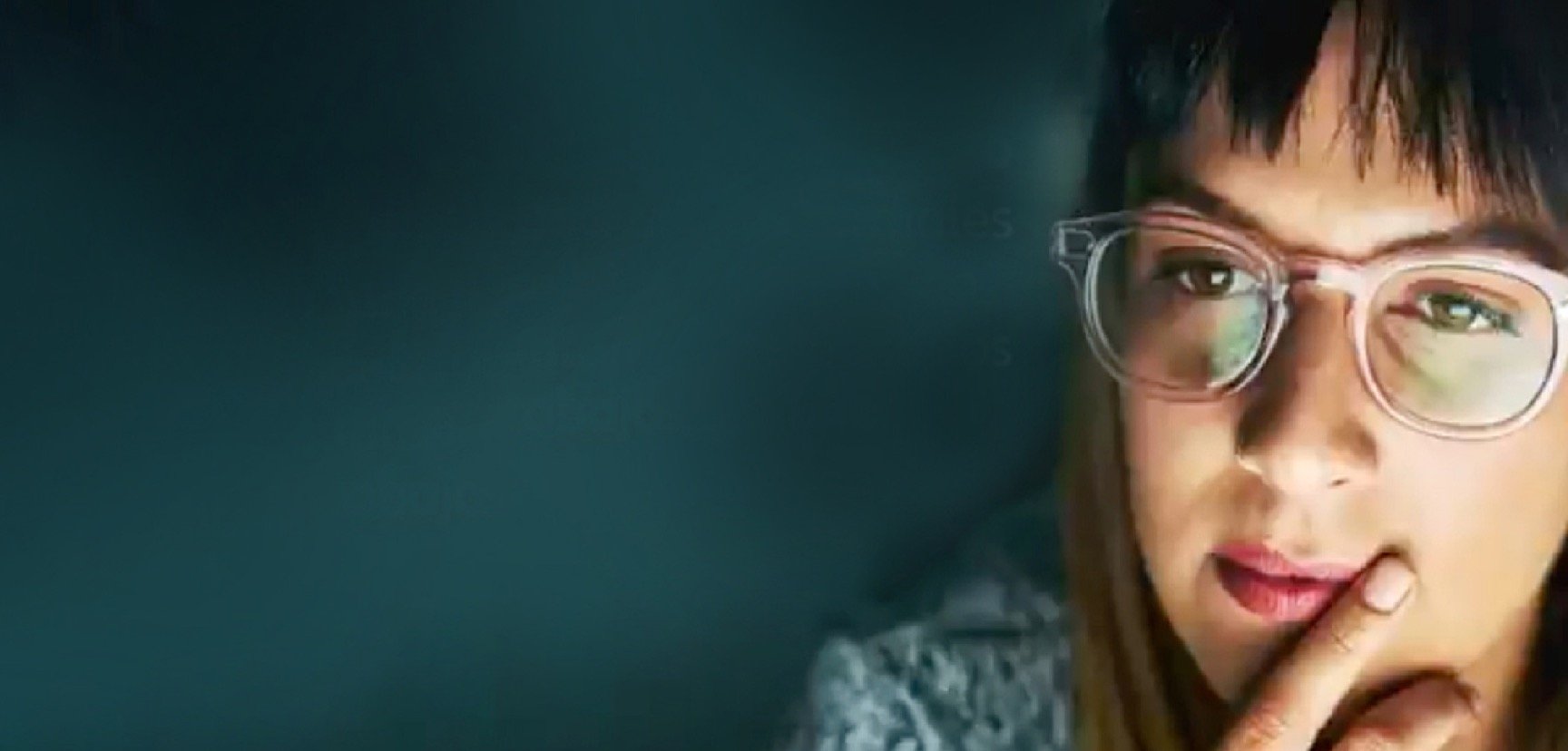 Young woman with glasses, in thoughtful pose