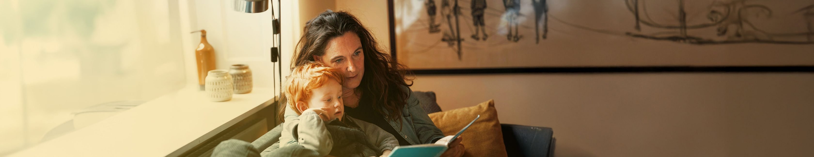 Woman with her blind daughter sitting happily on a couch