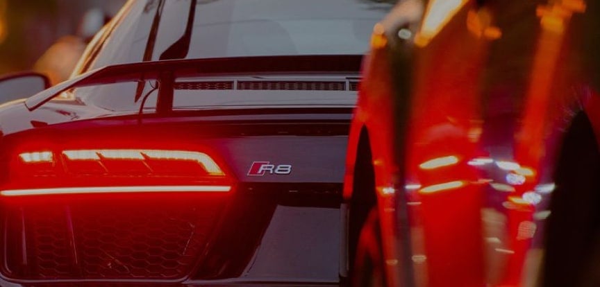 The brake lights shine on an expensive sportscar