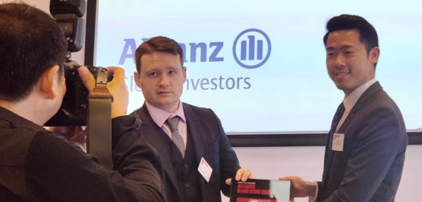 Two men pose for a photo accepting an award