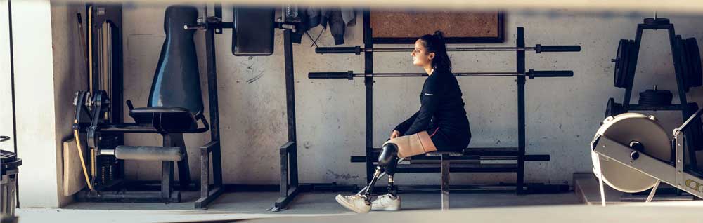Paralympic athlete sitting on a bench in the gym