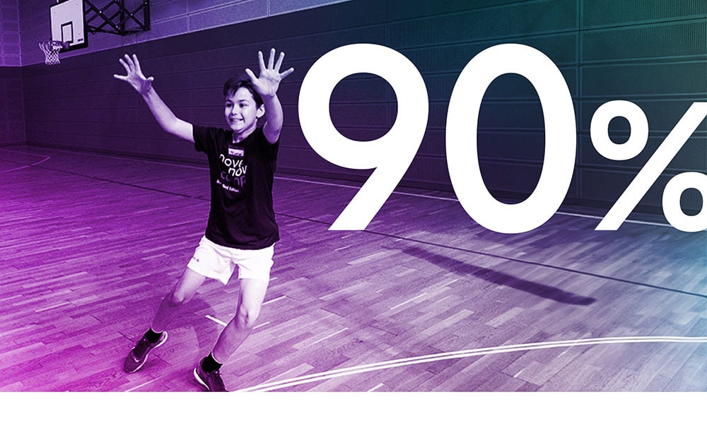 Boy holding up his arms while playing in the gym, figure 90%.