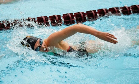The image of a woman swimmer performing the front crawl stroke