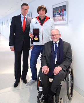 Photo of Paralympic photo exhibit   “Spirit in Motion”.  From left to right: Werner Zedelius, Member of the Board of Management of Allianz SE; Sebastian Dietz, Allianz employee and gold medalist in discus from the Paralympics in London; Sir Philip Craven, President of the IPC.  Source: Allianz