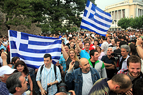 Protesters march on the streets in front of Thessaloniki White Tower, against the economic crisis in Greece.